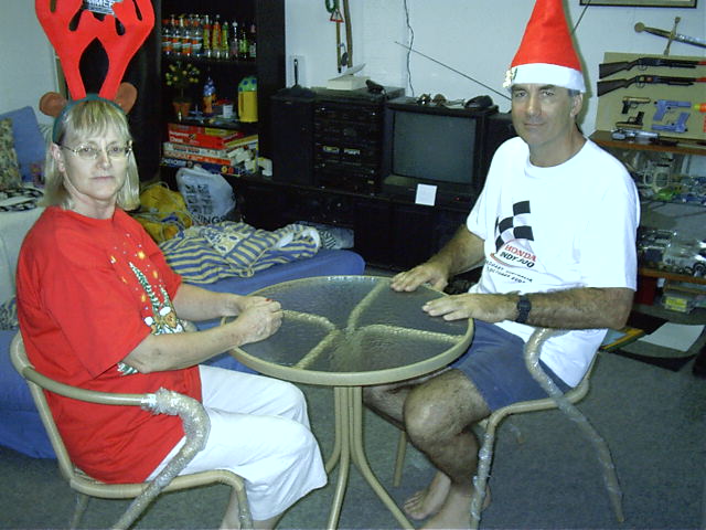 Mum and Dad test Megan's new table and chairs.