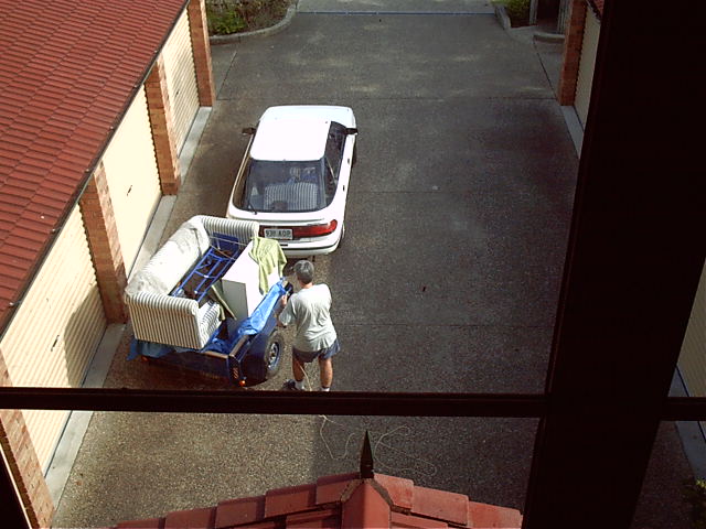 Dad starts unpacking the car.