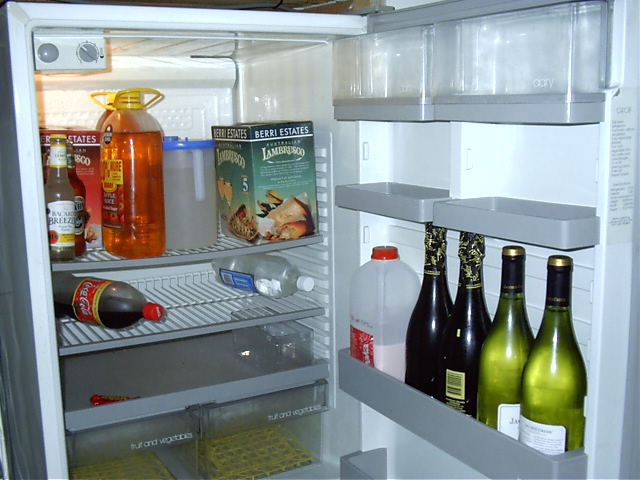 The bare essentials of a fridge. Apple juice, Beer, Wine and 1 Cherry Ripe.