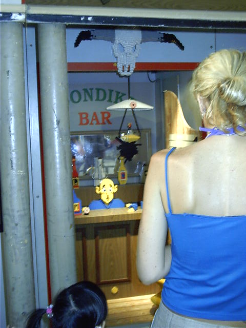 Meanwhile, at the local bar, Lady Blue-Shirt tries to get some business going.