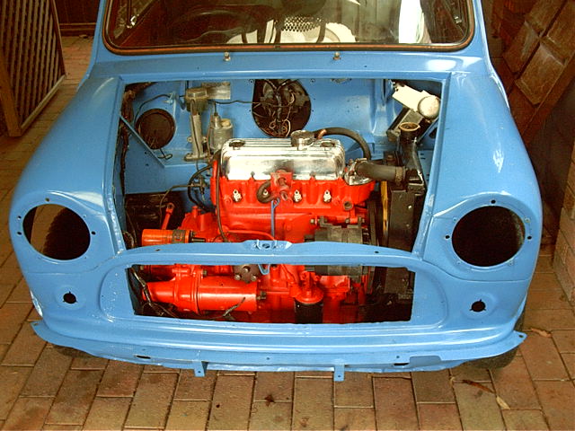 Dad puts the engine back in the blue mini.