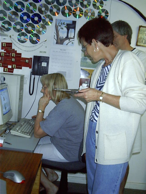 Karen looks over mum's should as she reads a birthday email