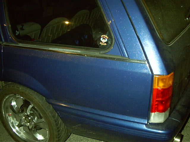 The car with the funky paint that reflected red