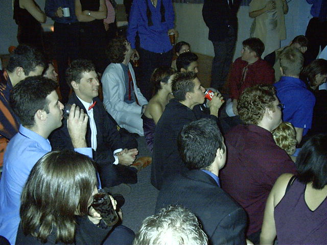 Everyone gathers around for a video to Trui and Shae as kids