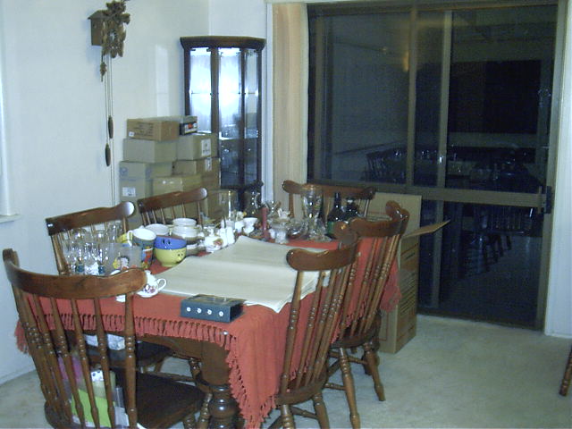 The dining table is filled with kitchen stuff