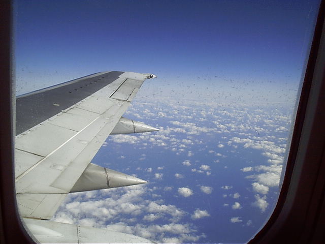 The wing of the plane going over