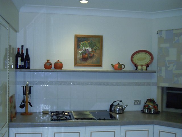 Painting hung in kitchen