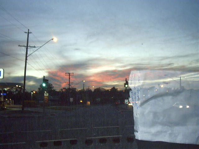 Enrique takes a pic of the setting sun, and my front car window