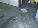 Concrete of garage after carpet tiles got flooded.