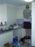Pat cleans the kitchen.