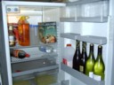 The bare essentials of a fridge. Apple juice, Beer, Wine and 1 Cherry Ripe.