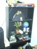 The bookself minus bottles but with other crap