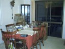 The dining table is filled with kitchen stuff