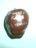 It's an apple with silver paint saying 'congrats' on becoming a teacher.